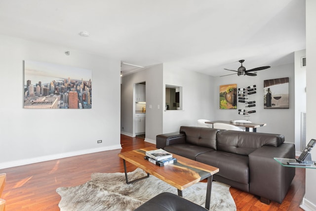 living room with ceiling fan and hardwood / wood-style flooring