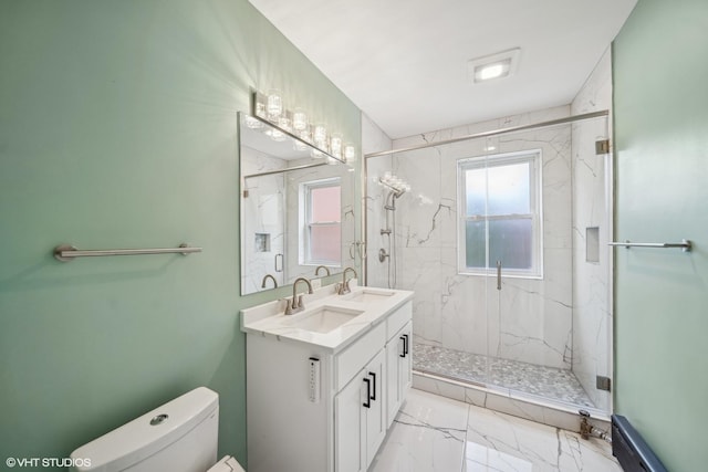 bathroom with toilet, vanity, and walk in shower