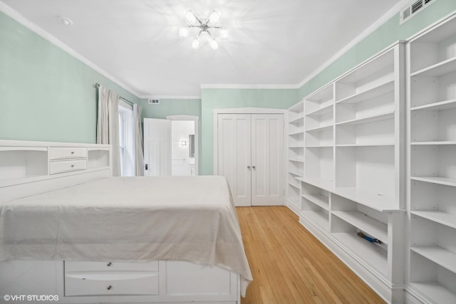 unfurnished bedroom featuring light wood-type flooring and crown molding