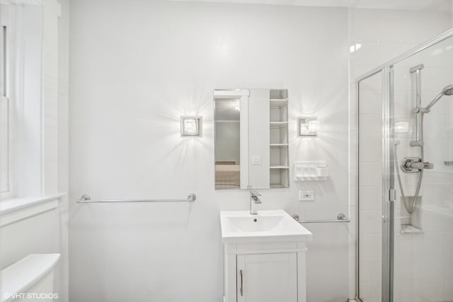 bathroom featuring toilet, vanity, and walk in shower