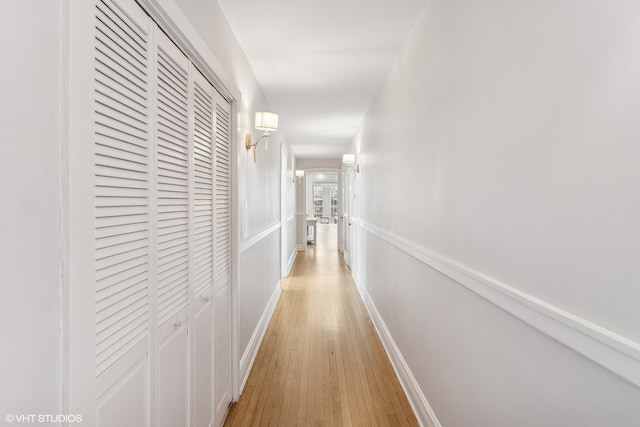 corridor featuring french doors and light hardwood / wood-style flooring