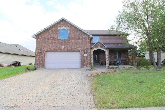 front of property with covered porch, a garage, and a front lawn