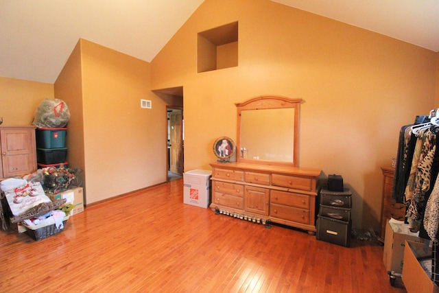 miscellaneous room with hardwood / wood-style flooring and vaulted ceiling