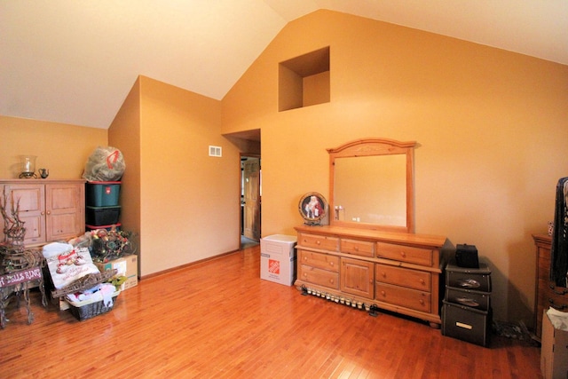 misc room with lofted ceiling and hardwood / wood-style flooring