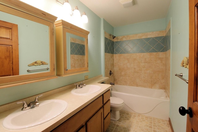 bathroom with tile patterned flooring, vanity, and toilet