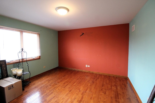 empty room with hardwood / wood-style flooring