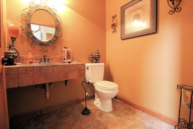 bathroom with tile patterned floors, toilet, and sink