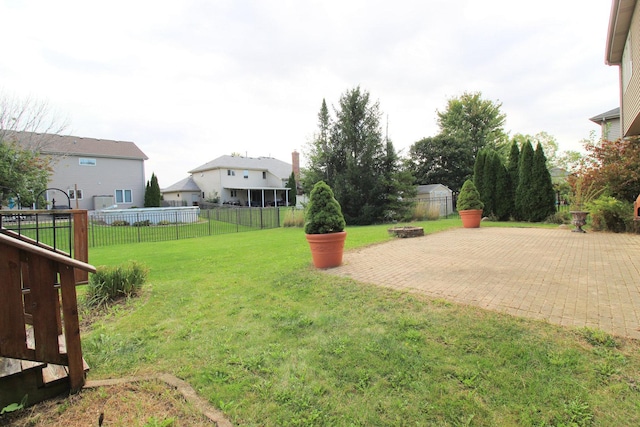 view of yard featuring a patio area and a fire pit