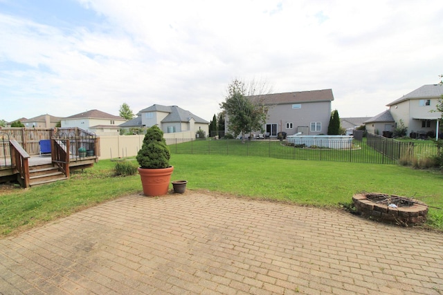 view of patio / terrace with a fire pit and a deck