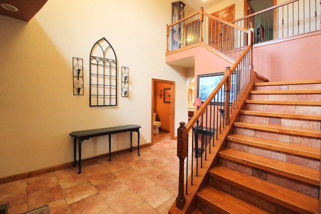 staircase with a high ceiling