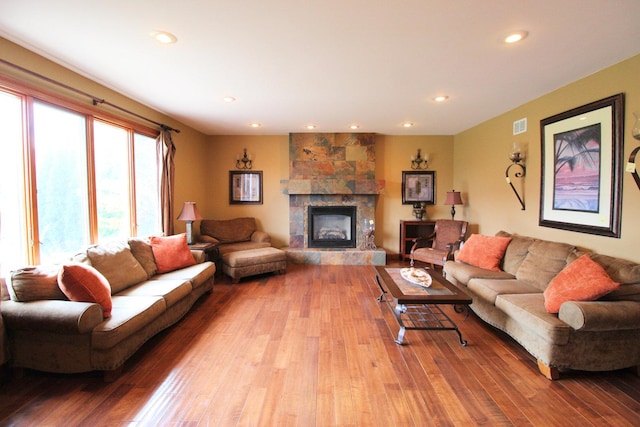 living room with light hardwood / wood-style floors and a fireplace