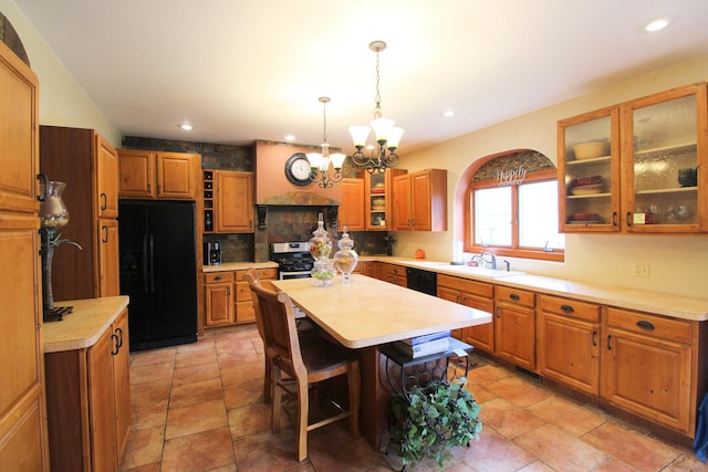 kitchen featuring backsplash, black appliances, sink, a kitchen island, and a chandelier