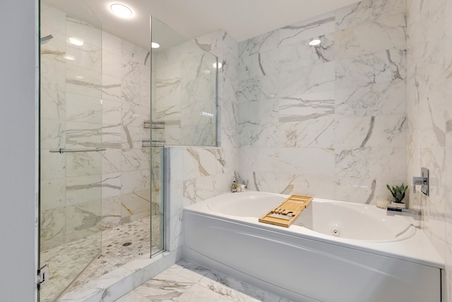 bathroom featuring tile walls and shower with separate bathtub