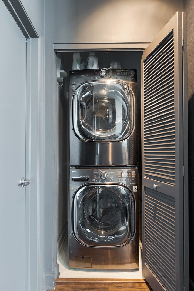 clothes washing area featuring stacked washing maching and dryer