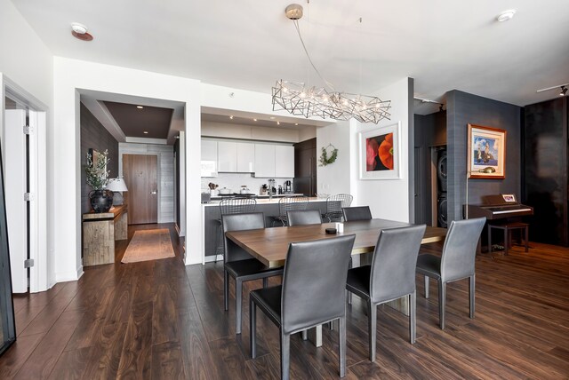 dining area with hardwood / wood-style floors and an inviting chandelier