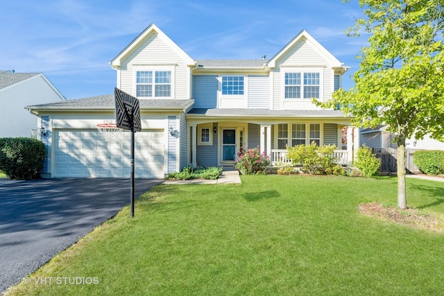 view of front of property with a front yard, a garage, and covered porch