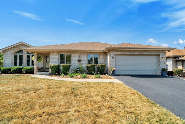 single story home with a front yard and a garage