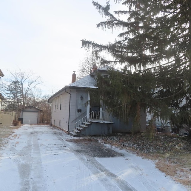 view of front of house with a garage and an outdoor structure