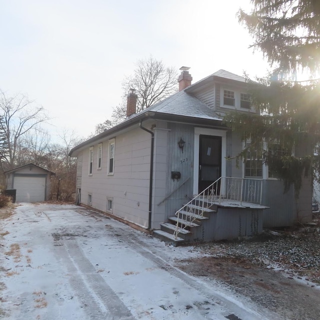 view of front facade featuring a garage and an outdoor structure