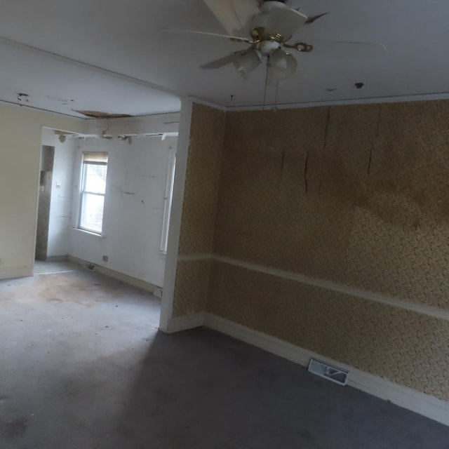 unfurnished room featuring ceiling fan and concrete flooring