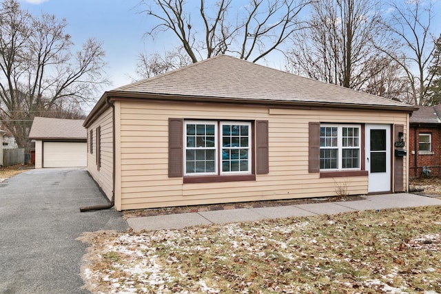 view of property exterior featuring a garage and an outdoor structure