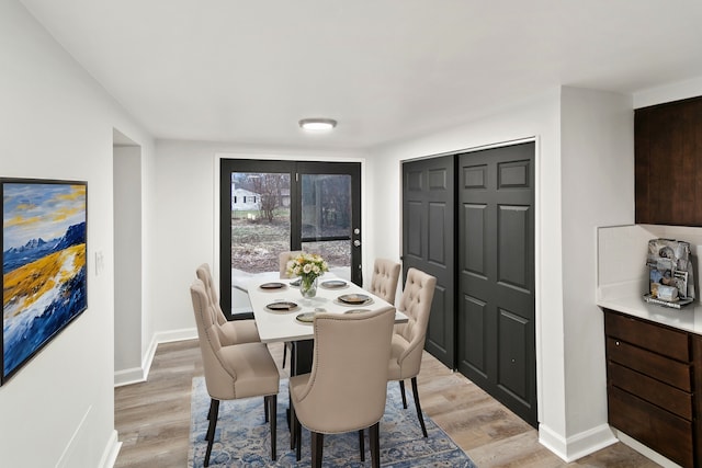 dining space with light hardwood / wood-style flooring