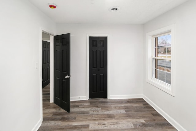 spare room featuring dark hardwood / wood-style flooring