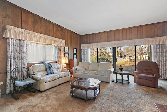 carpeted living room featuring plenty of natural light and wooden walls