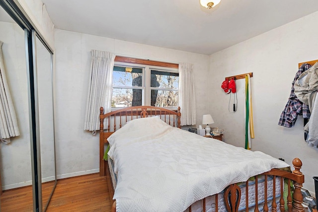 bedroom featuring a closet and light wood-type flooring