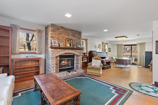 living room with a fireplace and light hardwood / wood-style flooring