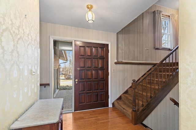 foyer entrance with lofted ceiling and light wood-type flooring