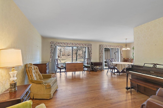 living area with hardwood / wood-style floors and a notable chandelier