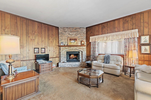 living room with carpet, wooden walls, and a brick fireplace