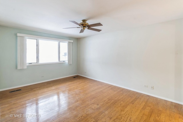 empty room featuring ceiling fan and light wood-type flooring