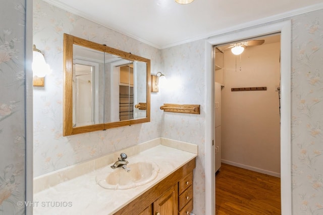 bathroom with vanity, crown molding, and hardwood / wood-style flooring