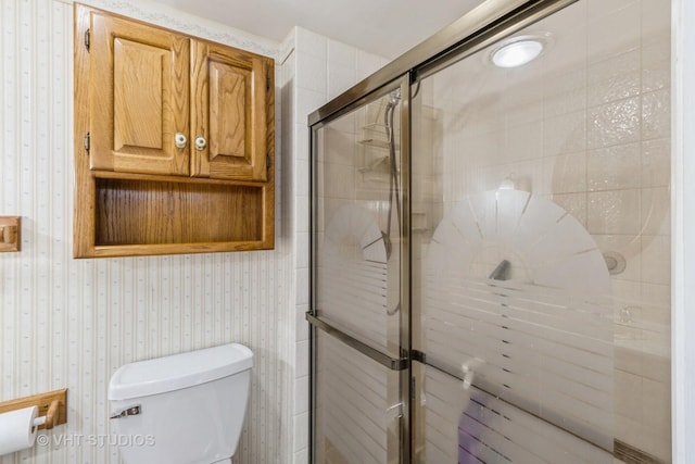 bathroom with toilet and walk in shower