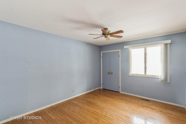 spare room with ceiling fan and light hardwood / wood-style floors