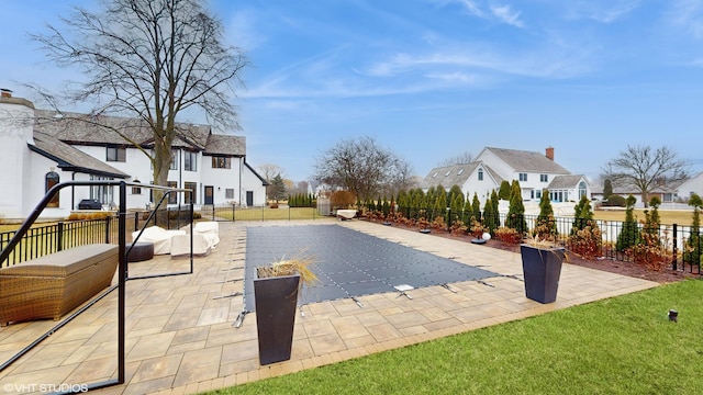 view of swimming pool with a lawn and a patio area