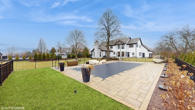 view of pool featuring a yard, an outdoor living space, and a patio