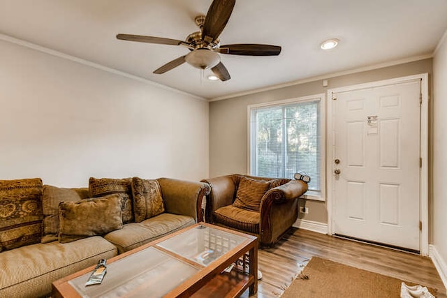 living room featuring crown molding, ceiling fan, and wood-type flooring