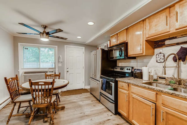 kitchen featuring light stone counters, ceiling fan, sink, electric range, and light hardwood / wood-style floors