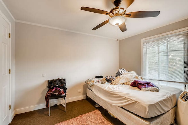 bedroom with ceiling fan, crown molding, and dark colored carpet