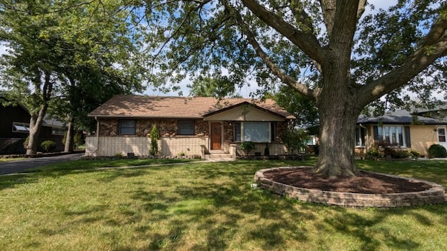 ranch-style home featuring a front yard