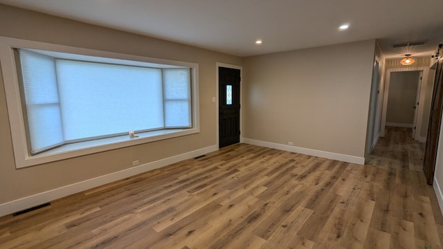 spare room with wood-type flooring