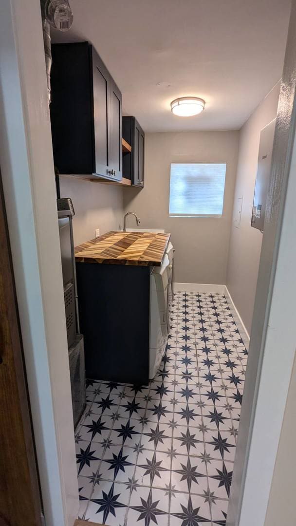 clothes washing area with cabinets and independent washer and dryer