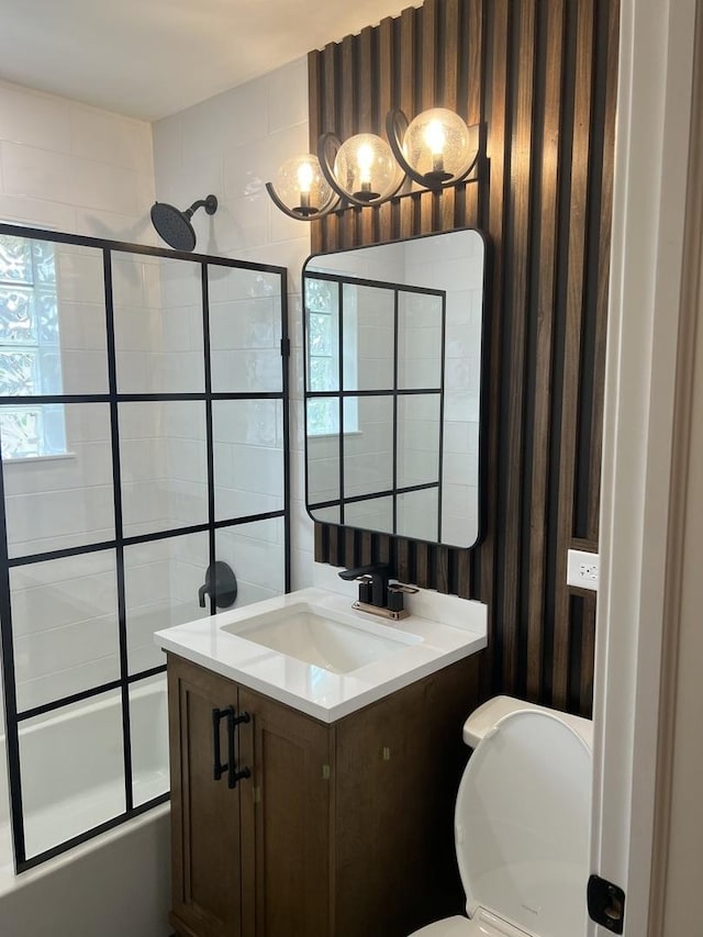 full bathroom with shower / bath combination with glass door, vanity, and toilet