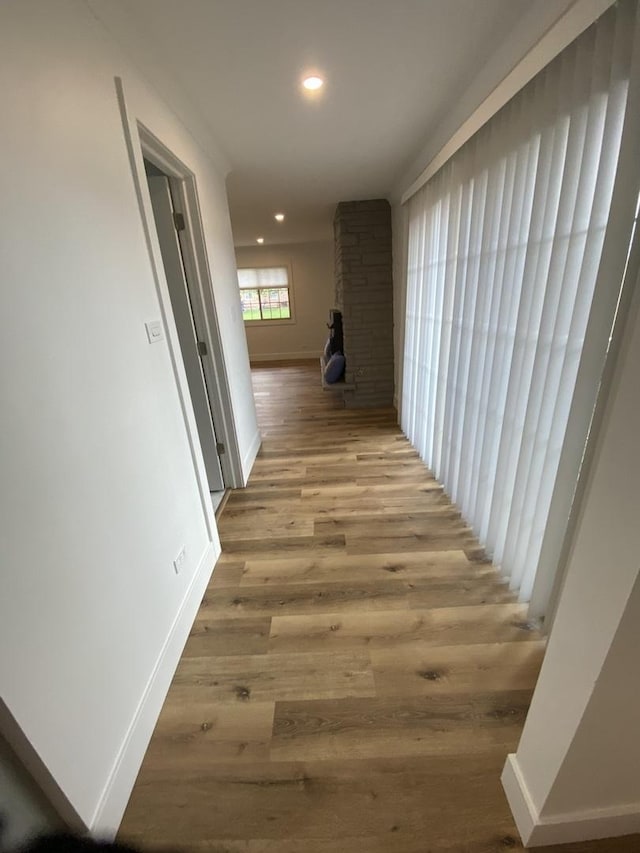 hallway with light hardwood / wood-style flooring