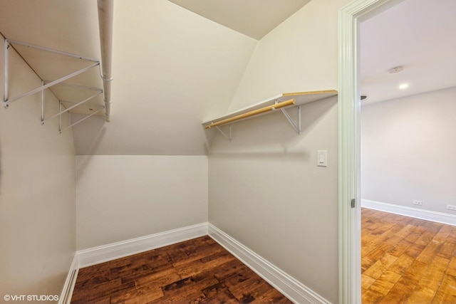 walk in closet featuring vaulted ceiling and dark hardwood / wood-style floors