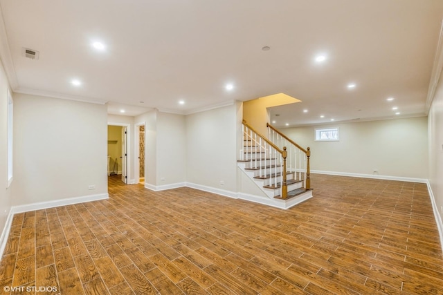 basement with wood-type flooring and ornamental molding