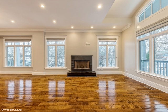 unfurnished living room with dark hardwood / wood-style flooring and crown molding